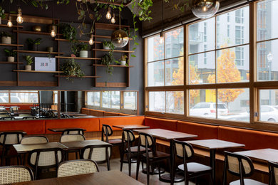 Inspiration for a mid-sized industrial concrete floor and gray floor kitchen/dining room combo remodel in Portland with gray walls