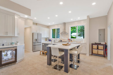 Large l-shaped kitchen photo in DC Metro with a farmhouse sink, quartz countertops, glass tile backsplash, stainless steel appliances and an island