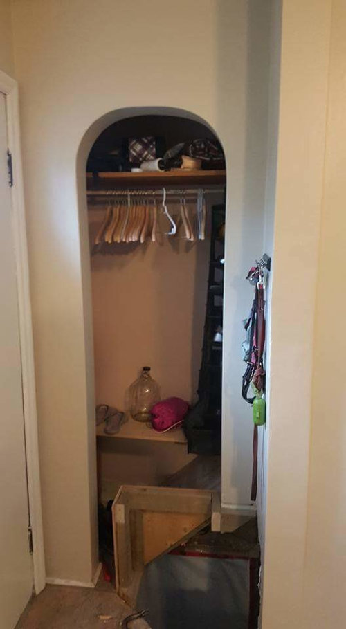 Front hall closet with basement stair bulkhead