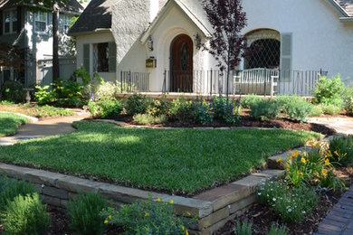 Inspiration for a mid-sized traditional partial sun front yard stone landscaping in Dallas.