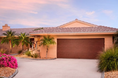 Mid-sized island style attached two-car garage photo in Other