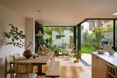 Design ideas for a medium sized midcentury dining room in London with medium hardwood flooring.