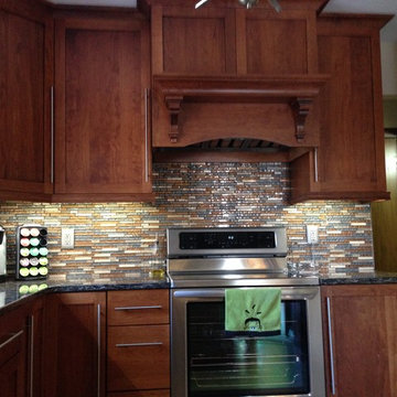 Omega Cabinetry. Plainfield door, Cherry wood, Nutmeg stain