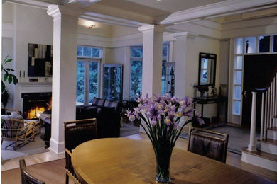 Example of a mid-sized transitional formal and open concept light wood floor and beige floor living room design in Seattle with white walls, a standard fireplace, a plaster fireplace and no tv