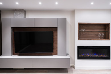 Small trendy open concept ceramic tile, brown floor and tray ceiling living room photo in Alicante-Costa Blanca with a wall-mounted tv, white walls, a hanging fireplace and a metal fireplace