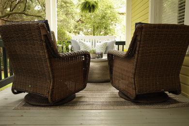 This is an example of a small transitional front porch design in Other with a roof extension.