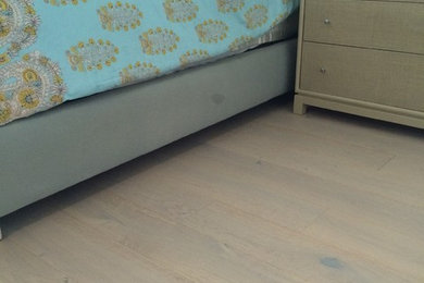 Example of a trendy guest light wood floor bedroom design in Miami with green walls