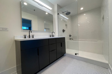 Inspiration for a large master white tile and porcelain tile mosaic tile floor, white floor and double-sink drop-in bathtub remodel in Chicago with flat-panel cabinets, black cabinets, quartz countertops, white countertops and a freestanding vanity