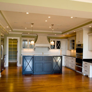 Large traditional kitchen pantry designs - Kitchen pantry - large traditional u-shaped medium tone wood floor kitchen pantry idea in Louisville with a drop-in sink, recessed-panel cabinets, distressed cabinets, granite countertops, white backsplash, ceramic backsplash, stainless steel appliances and an island