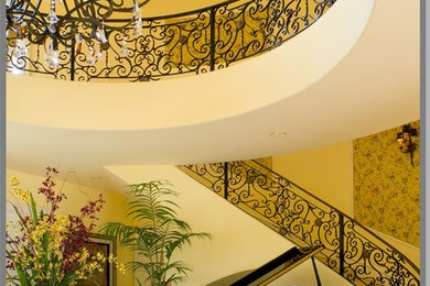 This is an example of a traditional curved staircase in Los Angeles.