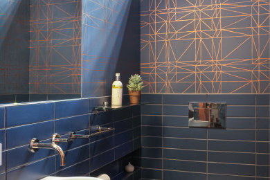 Example of a mid-sized 1960s 3/4 blue tile and cement tile dark wood floor, brown floor, single-sink, wood ceiling and wallpaper bathroom design in San Francisco with blue cabinets, a wall-mount toilet and a floating vanity