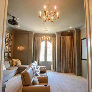 This is an example of a large classic enclosed home cinema in New Orleans with grey walls, carpet, a projector screen and grey floors.