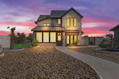 Inspiration for a mid-sized contemporary white two-story stone exterior home remodel in Dallas with a metal roof