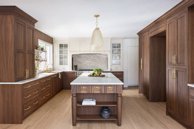 Example of a large transitional u-shaped dark wood floor and brown floor eat-in kitchen design in DC Metro with an undermount sink, shaker cabinets, brown cabinets, quartzite countertops, gray backsplash, quartz backsplash, stainless steel appliances, an island and beige countertops