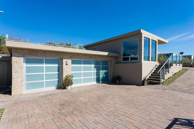 Photo of a huge modern front yard concrete paver driveway in Orange County.