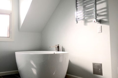 Inspiration for a mid-sized master ceramic tile freestanding bathtub remodel in San Francisco with gray walls