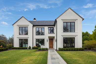 Large transitional white two-story brick exterior home idea in Other with a shingle roof and a gray roof