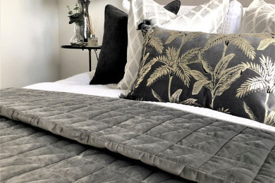 Medium sized modern guest bedroom in Hampshire with white walls, carpet and grey floors.