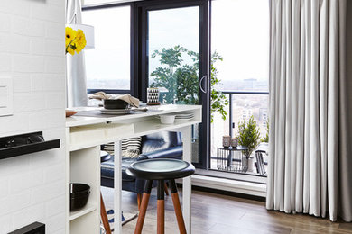 Example of a small trendy open concept laminate floor and brown floor living room design in Toronto with a tv stand and white walls