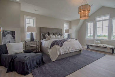 Example of a large transitional master light wood floor and gray floor bedroom design in Columbus with gray walls, a standard fireplace and a stone fireplace