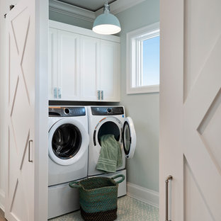 Classic separated utility room in Miami with recessed-panel cabinets, white cabinets, grey walls, a side by side washer and dryer and blue floors.