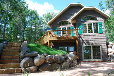 This is an example of a mid-sized transitional partial sun front yard concrete paver retaining wall landscape in Other for summer.