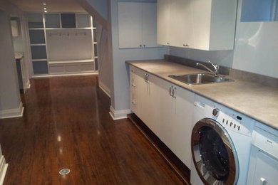 Mid-sized trendy look-out dark wood floor basement photo in Toronto with blue walls