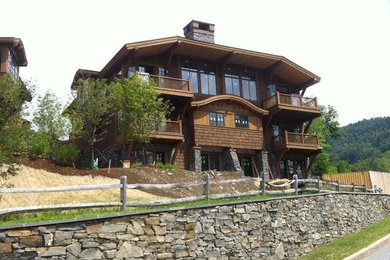 Large elegant brown three-story exterior home photo in Burlington
