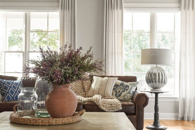 Large country open concept medium tone wood floor and brown floor family room photo in Dallas with gray walls