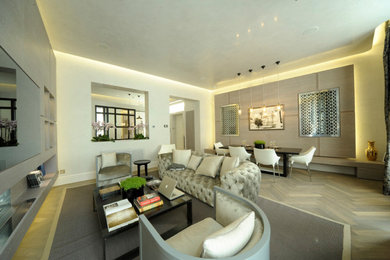 Photo of a medium sized contemporary grey and white open plan living room feature wall in London with a home bar, a ribbon fireplace, a stone fireplace surround, a concealed tv, grey floors and a coffered ceiling.