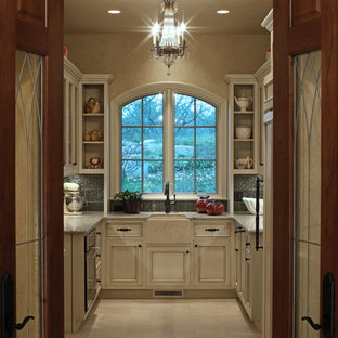 Huge traditional kitchen pantry appliance - Inspiration for a huge timeless u-shaped limestone floor kitchen pantry remodel in Omaha with a farmhouse sink, beaded inset cabinets, distressed cabinets, quartz countertops, gray backsplash, metal backsplash, paneled appliances and no island