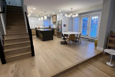 Mid-sized minimalist kitchen photo in Other with flat-panel cabinets, light wood cabinets, white backsplash, marble backsplash and stainless steel appliances