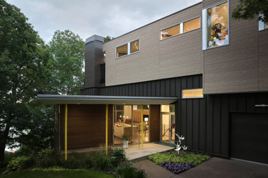 Inspiration for a mid-sized mid-century modern brown two-story concrete fiberboard and clapboard exterior home remodel in Minneapolis
