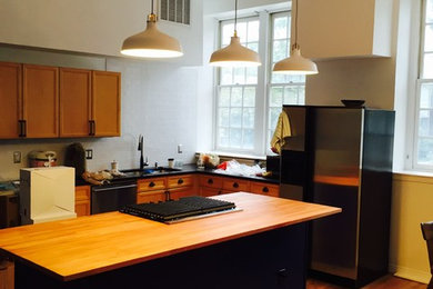 Eat-in kitchen - large 1960s l-shaped light wood floor eat-in kitchen idea in Denver with a double-bowl sink, shaker cabinets, light wood cabinets, wood countertops, stainless steel appliances and an island