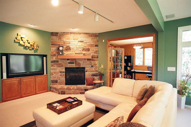 Example of a classic carpeted family room design in Minneapolis with green walls, a corner fireplace, a stone fireplace and a media wall