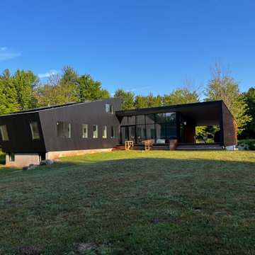 Two intersecting volumes on a summer lawn
