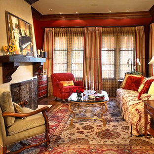 Mediterranean formal enclosed living room in Los Angeles with red walls, medium hardwood flooring, a standard fireplace and a plastered fireplace surround.