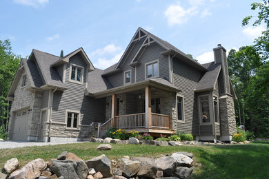 This is an example of a large traditional three-storey grey exterior in Ottawa with wood siding.
