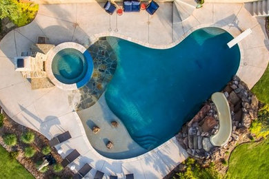 Inspiration for a huge coastal backyard custom-shaped water slide remodel in Oklahoma City
