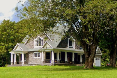 Mid-sized transitional gray two-story stone gable roof photo in Philadelphia