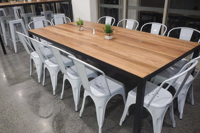 Photo of an industrial dining room in Gold Coast - Tweed.