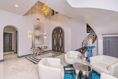 Huge trendy marble floor entryway photo in Austin with gray walls and a metal front door