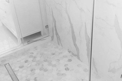 Doorless shower photo in Miami with white walls and marble countertops