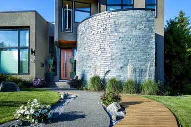 This is an example of a mid-sized contemporary two-storey stucco brown exterior in Calgary.