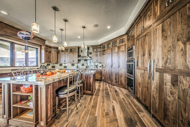 Large mountain style u-shaped medium tone wood floor open concept kitchen photo in Salt Lake City with medium tone wood cabinets, granite countertops, multicolored backsplash, porcelain backsplash, stainless steel appliances and an island