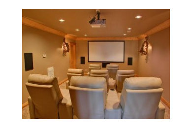 Example of a large classic enclosed carpeted and beige floor home theater design in Austin with beige walls and a projector screen