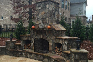 Example of a classic backyard patio kitchen design in Charlotte with no cover