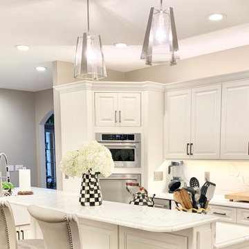 Ivory White Kitchen With Marble Look Quartz Counters and Splash