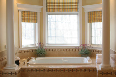 Example of a large classic master beige tile and ceramic tile beige floor and ceramic tile bathroom design in New York with beige walls, raised-panel cabinets, dark wood cabinets, an undermount sink and granite countertops