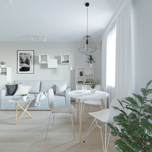 Inspiration for a small scandinavian open plan living room in Other with grey walls, a wall mounted tv, laminate floors and pink floors.